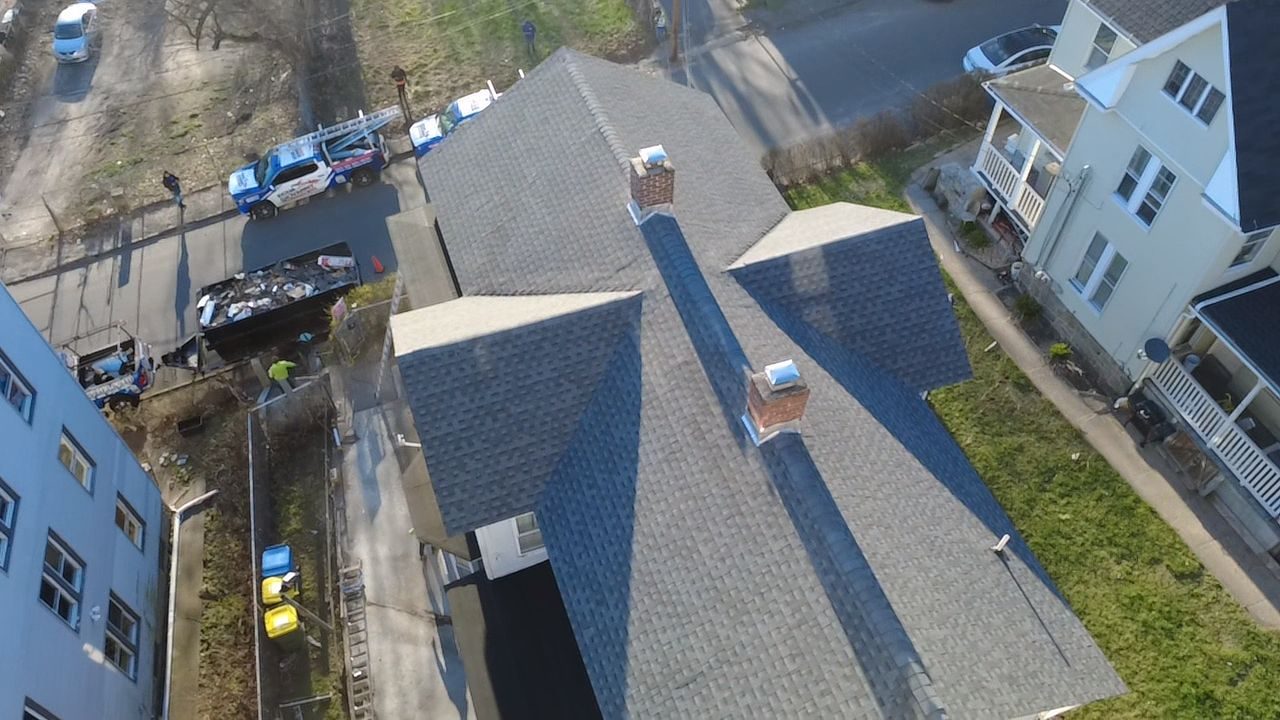 Aerial drone view of a completed new-shingle roof replacement in Connecticut