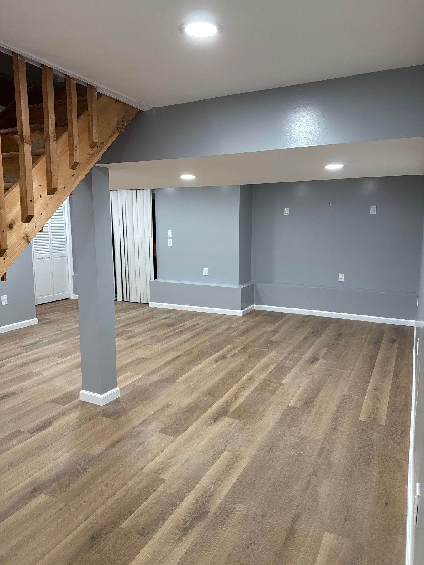 A finished basement with light flooring